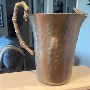 Hammered aluminum Pitcher with Bamboo handle.